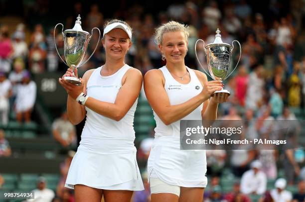 Katerina Siniakova and Barbora Krejcikova with their trophies after winning the Ladies Doubles on day twelve of the Wimbledon Championships at the...