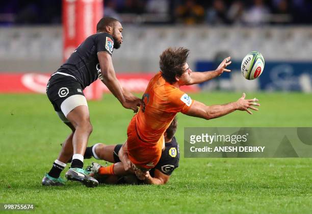 Sharks' centre Lukhanyo Am tackels Jaguares' loose forward Pablo Matera during the Super Rugby match between the Sharks and the Jaguares at the Kings...