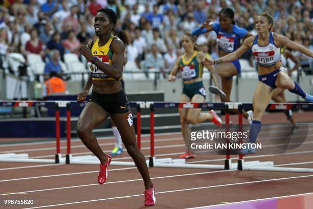 Jamaica's Janieve Russell sprints away from Britain's Meghan Beesley on her way to winning the women's 400m hurdles during the Athletics World Cup...
