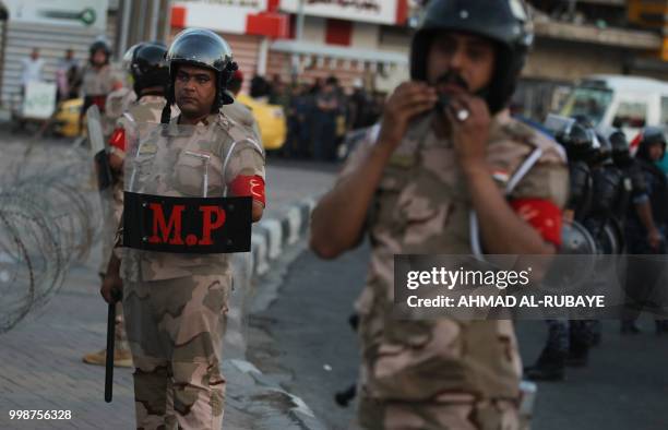 Members of the Iraqi security forces are deployed in the capital Baghdad's Tahrir Square during demonstrations against unemployment on July 14, 2018....