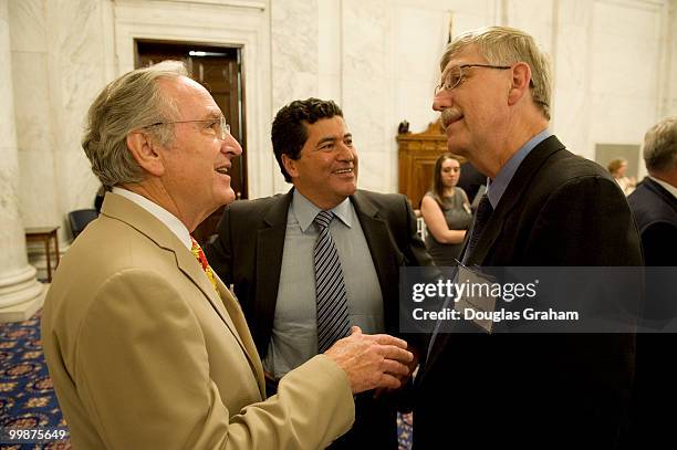 Senate Agriculture Chairman Tom Harkin, D-Iowa, talks with Dr. Francis Collins, right, designated NIH director, and Dr. Elias Zerhouni, former NIH...