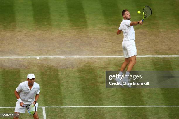 Mike Bryan and Jack Sock of The United States return against Raven Klaasen of South Africa and Michael Venus of New Zealand during the Men's Doubles...