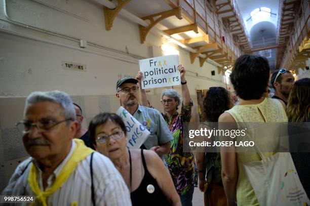 Demonstrators enter the former mens Modelo prison, a symbol of the Francoist repression in Catalonia, on July 14, 2018 in Barcelona after a...