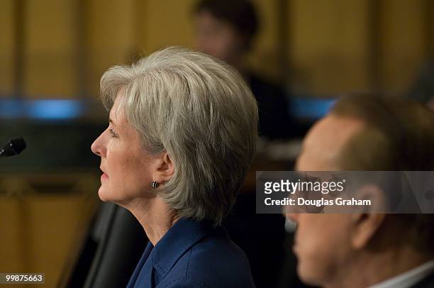 Gov. Kathleen Sebelius, D-Kan., listens to former senator Bob Dole as his testifies before the Senate Finance full committee hearing on the her...