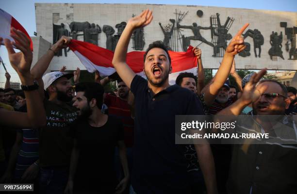 Iraqis holding national flags demonstrate against unemployment in the capital Baghdad's Tahrir Squareon July 14, 2018. - Two demonstrators were...