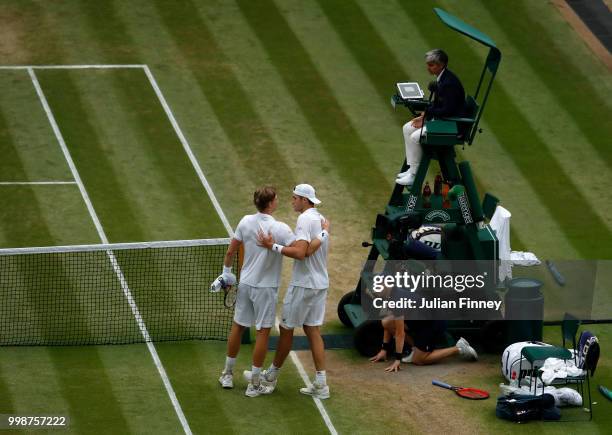 Kevin Anderson of South Africa hugs John Isner of The United States after their Men's Singles semi-final match on day eleven of the Wimbledon Lawn...