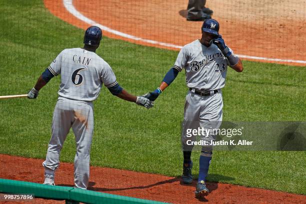 Keon Broxton of the Milwaukee Brewers celebrates with Lorenzo Cain of the Milwaukee Brewers after hitting a RBI single in the fifth inning during...