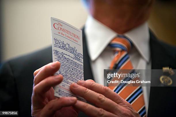 Rep. Paul C. Broun, R-GA., holds a copy of the Constitution that he carries with him at all times in his office in the Cannon House Office Building...
