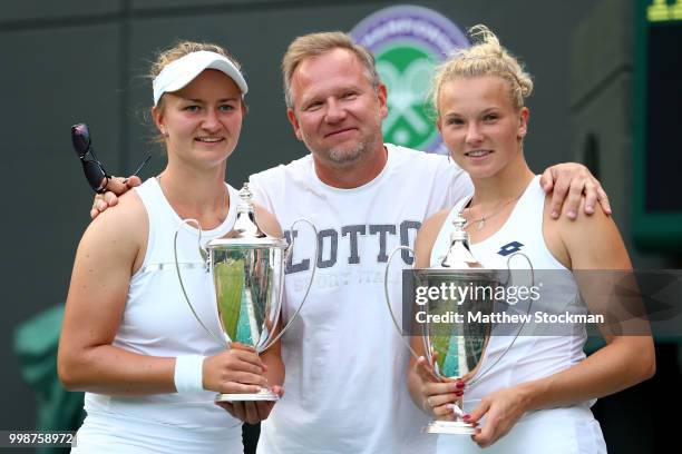 Winners Barbora Krejcikova and Katerina Siniakova of Czech Republic pose with their trophies and coach after their victory against Nicole Melichar of...