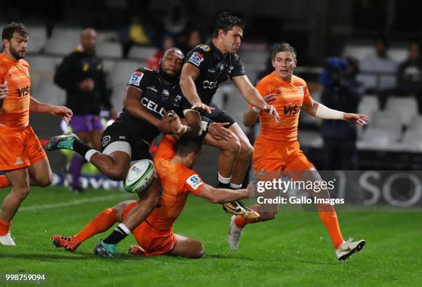 Lukhanyo Am and Kobus van Wyk of the Cell C Sharks jump over Bautista Ezurra of the Jaguares during the Super Rugby match between Cell C Sharks and...