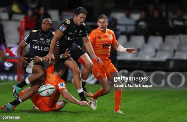 Lukhanyo Am and Kobus van Wyk of the Cell C Sharks jump over Bautista Ezurra of the Jaguares during the Super Rugby match between Cell C Sharks and...