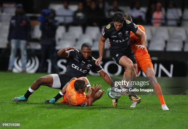 Lukhanyo Am and Kobus van Wyk of the Cell C Sharks jump over Bautista Ezurra of the Jaguares during the Super Rugby match between Cell C Sharks and...