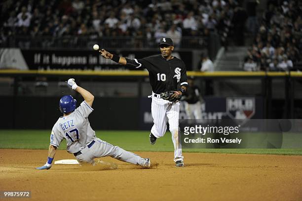Alexei Ramirez of the Chicago White Sox turns a double play over a sliding Chris Getz of the Kansas City Royals in the eighth inning on May 03, 2010...