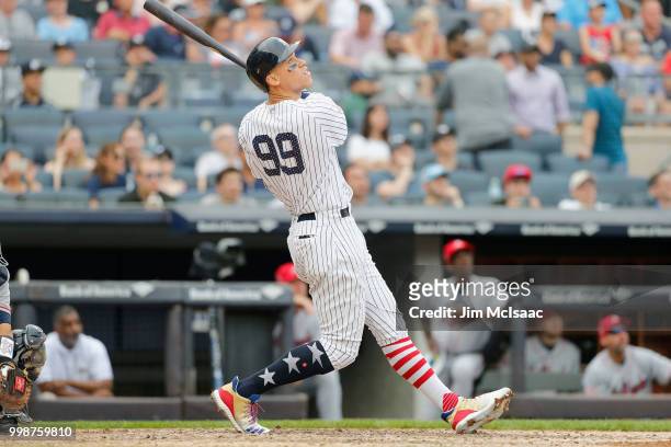 Aaron Judge of the New York Yankees follows through on a seventh inning home run against the Atlanta Braves at Yankee Stadium on July 4, 2018 in the...