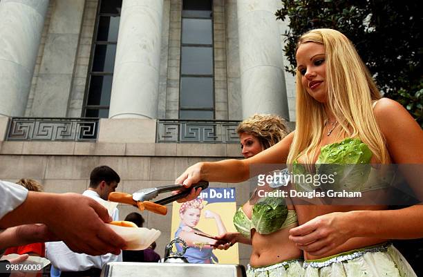 Wearing a skimpy bikini made of lettuce leaves, Playboy magazine's Miss July 2002, Lauren Anderson serves up some veggie-dog's to staffers in front...