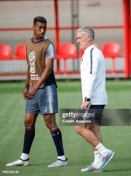Head coach Didier Deschamps and Presnel Kimpembe of France are seen during a training session ahead of the World Cup 2018 final match against...