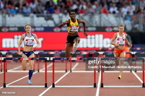 Janieve Russell of Jamaica leads Meghan Beesley of Great Britain and Joanna Linkiewicz of Poland during the Women's 400m Hurdles during day one of...