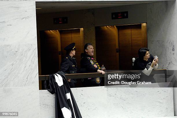 Protesters are removed from the 5th floor of the Hart Senate Office Building by U.S. Capitol Hill Police after they hung anti-war banners from the...