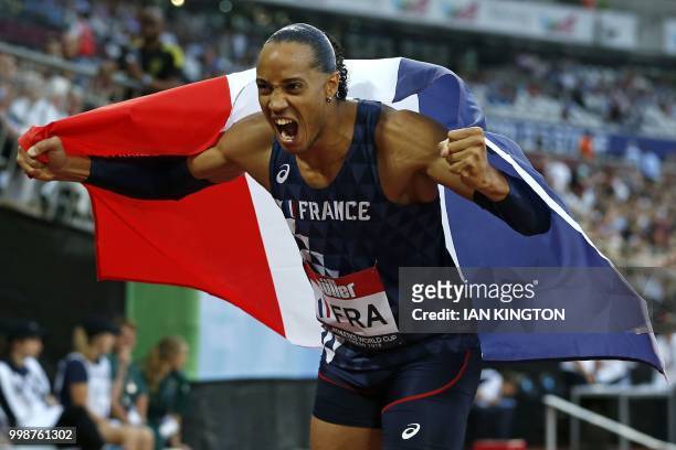France's Pascal Martinot-Lagarde celebrates with the French flag after winning the men's 110m hurdles during the Athletics World Cup team competition...