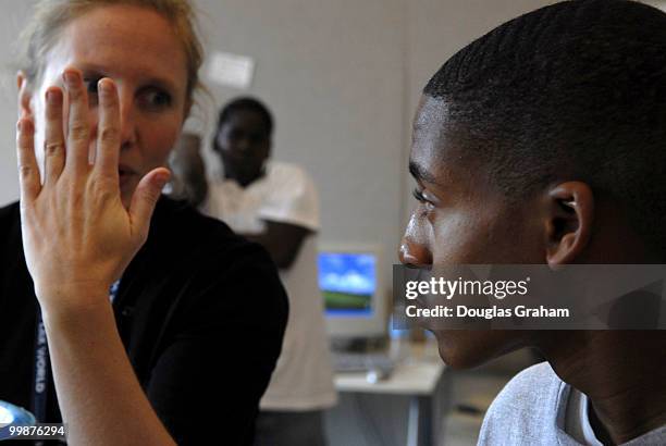 Liz Guthrie helps Stefan Becton with his photo project that will be displayed at the National Building Museum, "Investigating Where We Live" outreach...