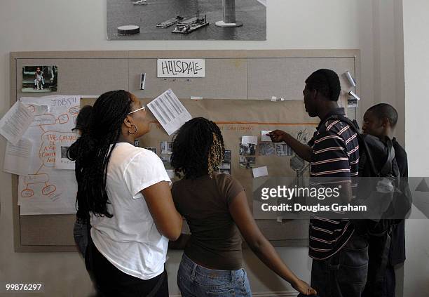 Krista Dugger, Natalie Matthews, Adrienne Fenton, Oluwafemi Morrisey and Arrie Hurd fine tune their photo project at a story board used for planning...