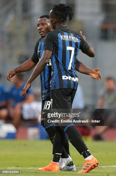 Yann Karamoh of FC Internazionale celebrates his goal with teammate Kwadwo Asamoah during the pre-season friendly match between Lugano and FC...