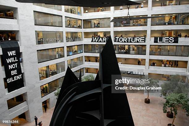 Protesters are removed from the 5th floor of the Hart Senate Office Building by U.S. Capitol Hill Police after they hung anti-war banners from the...