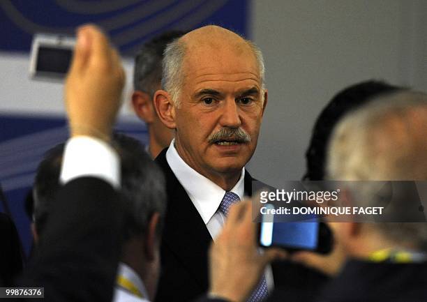 Greek Prime Minister George Papandreou talks to journalists after giving a press conference during the Sixth Summit of Heads of State and Government...