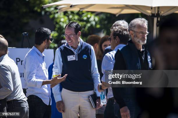 Sundar Pichai, chief executive officer of Google Inc., left, speaks with Randall Stephenson, chairman and chief executive officer of AT&T Inc.,...