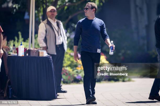 Mark Zuckerberg, chief executive officer and founder of Facebook Inc., walks the grounds after the morning session at the Allen & Co. Media and...