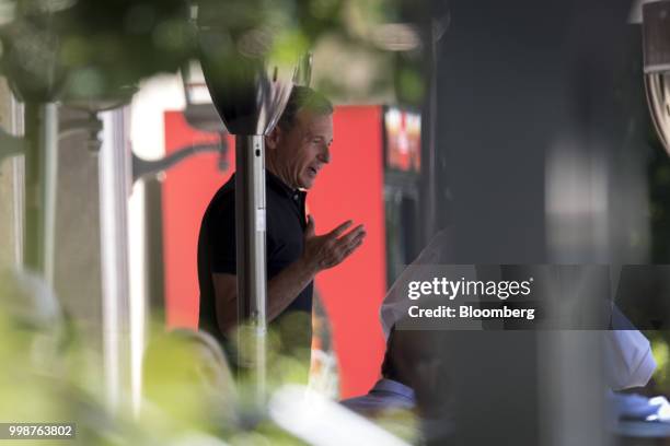 Robert Iger, chief executive officer of the Walt Disney Co., speaks with an attendee after the morning session at the Allen & Co. Media and...