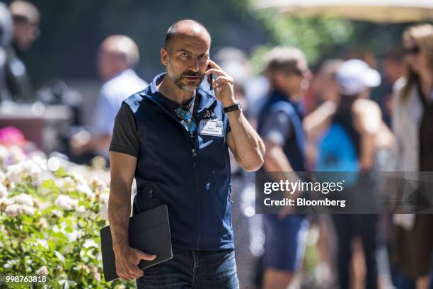Dara Khosrowshahi, chief executive officer of Uber Technologies Inc., speaks on the phone after the morning session at the Allen & Co. Media and...