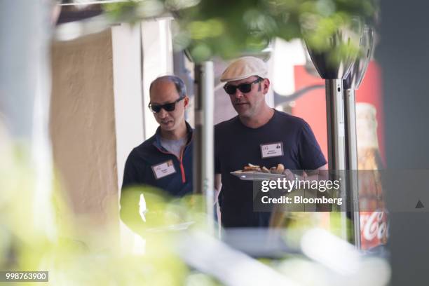 James Murdoch, chief executive officer of Twenty-First Century Fox Inc., right, and Roger Kuo, senior vice president of Dodge and Cox Funds, walk to...