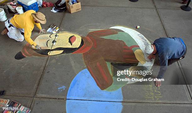 Michael Kirby, and his dad Harry with Ambient Planet, work an a sidewalk mural of a Terra Cotta Warrior guardians of China's First Emperor. The mural...