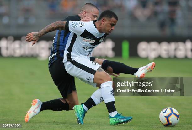 Carlos Junior of FC Lugano is challenged by Radja Nainggolan of FC Internazionale during the pre-season friendly match between Lugano and FC...