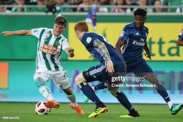 Stephan Auer of Rapid, Matti Steinmann of Hamburger SV and Moritz Broni Kwarteng of Hamburger SV in action during the Pre Season Friendly match...