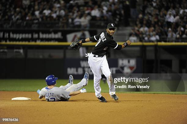 Alexei Ramirez of the Chicago White Sox turns a double play over a sliding Chris Getz of the Kansas City Royals in the eighth inning on May 03, 2010...