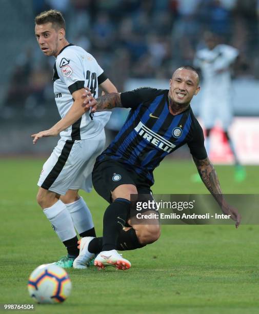 Radja Nainggolan of FC Internazionale competes for the ball with Mario Piccinocchi of FC Lugano during the pre-season friendly match between Lugano...
