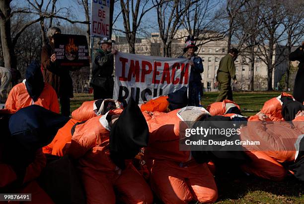 Protesters dressed in orange jump suits protest the war in the Upper Senate Park in an attempt to urge the new 110th Congress to seek impeachment for...