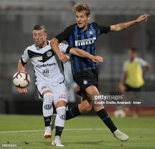 Facundo Colidio of FC Internazionale competes for the ball with Dragan Mihajlovic of FC Lugano during the pre-season friendly match between Lugano...