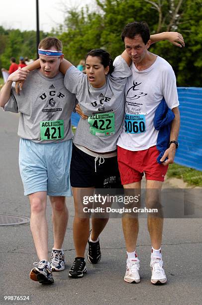 Myal Greene and Judge John Mott helps Jessica Taylor finish the 24th Annual Capitol Challenge at Anacostia Park in Wahington, D.C.