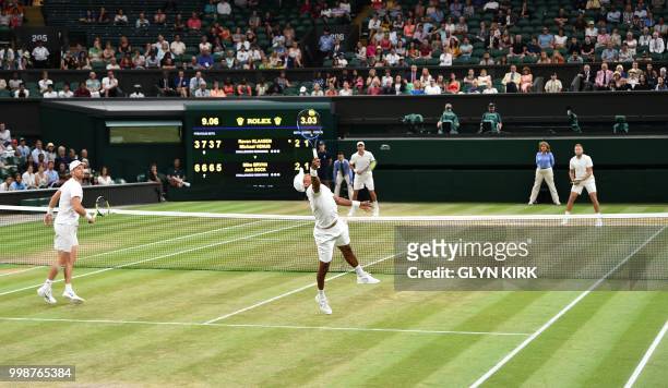 South Africa's Raven Klaasen and New Zealand's Michael Venus return against US player Mike Bryan and US player Jack Sock during their mens' doubles...