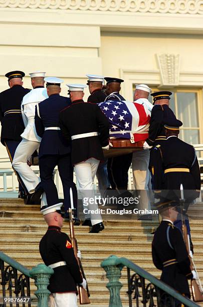 Crowds watch the 3rd Infantry Division Old Guard transfer former President Ronald Reagan's casket to a horse-drawn caisson to take him to to lie in...