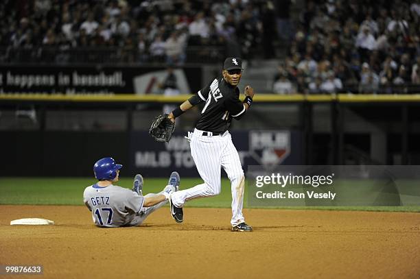 Alexei Ramirez of the Chicago White Sox turns a double play over a sliding Chris Getz of the Kansas City Royals in the eighth inning on May 03, 2010...