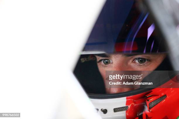 Ruben Garcia, Jr., driver of the Max Siegel Inc. Toyota, looks on from the car in the garage during practice the NASCAR K&N Pro Series East King...