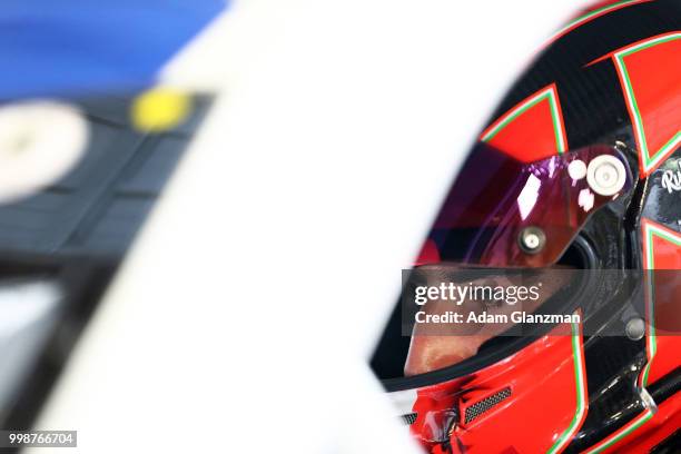 Ruben Garcia, Jr., driver of the Max Siegel Inc. Toyota, looks on from the car in the garage during practice for the NASCAR K&N Pro Series East King...