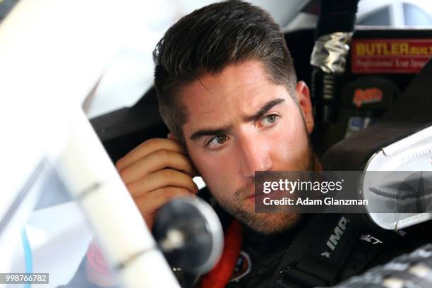 Ruben Garcia, Jr., driver of the Max Siegel Inc. Toyota, looks on from the car in the garage during practice for the NASCAR K&N Pro Series East King...