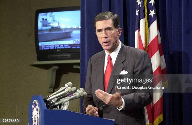 Charles S. Robb, D-Va., during a press conference on the attack of the U.S.S. Cole. In the background is the C-Span report of the attack.