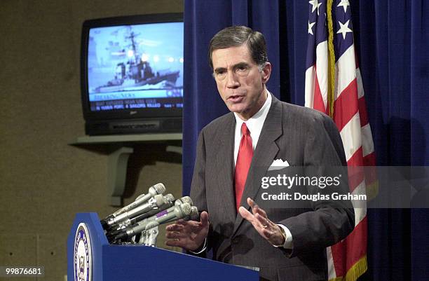 Charles S. Robb, D-Va., during a press conference on the attack of the U.S.S. Cole. In the background is the C-Span report of the attack.