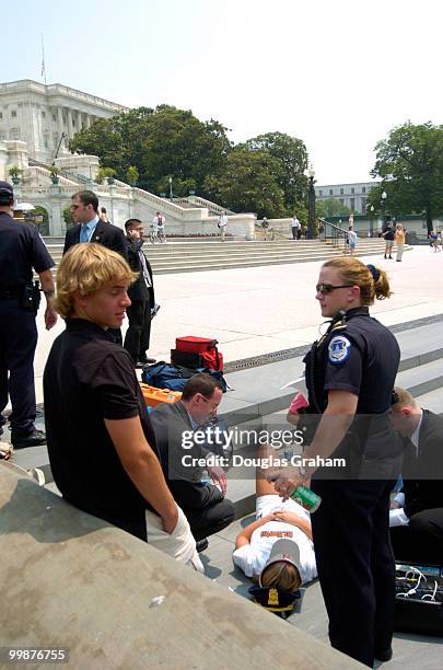 Tourist passed out from the heat in front of the U.S. Capitol. Security is tight as the U.S. Capitol perpares for the arrival of former President...